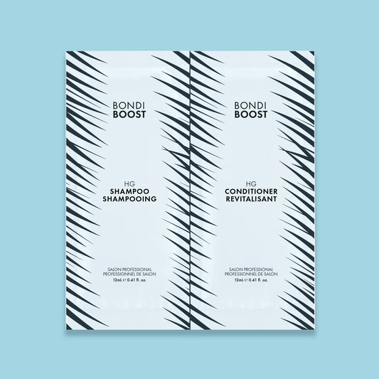 Two Bondi Boost hair care products packaging, one for shampoo and one for conditioner, with a white and blue palm leaf design.